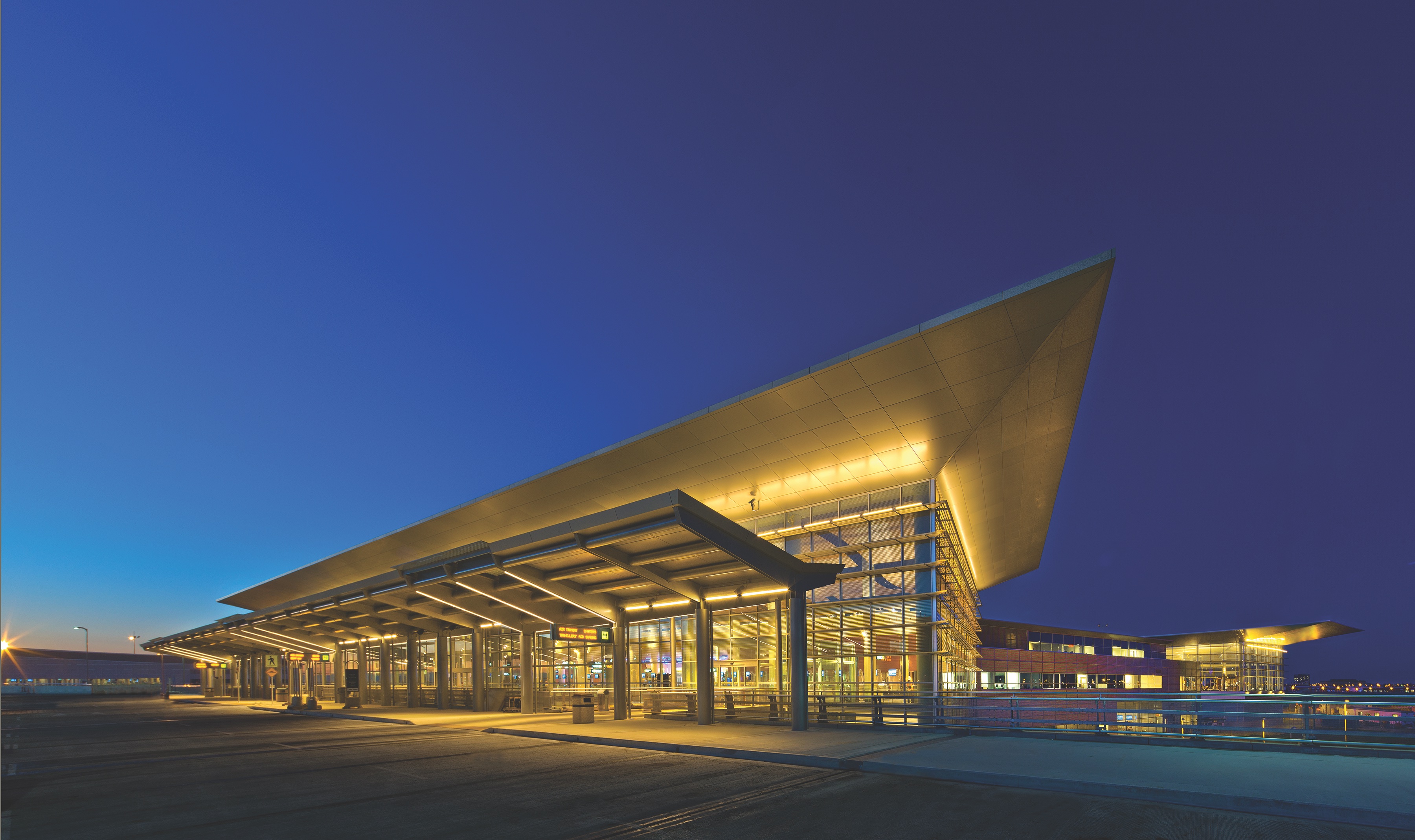 The airport terminal building at night.