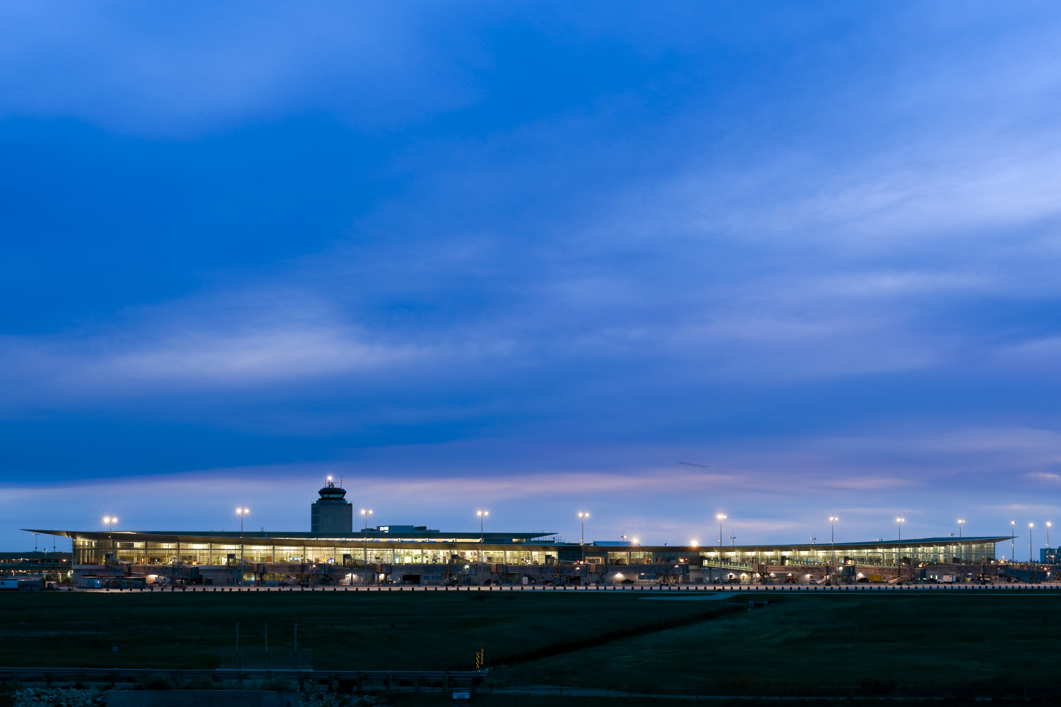 The terminal building from a distance depicting the vast prairie landscape and horizon.