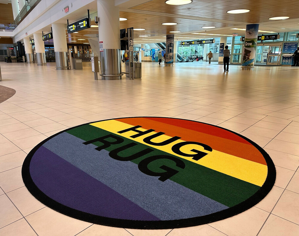 Un Hug Rug sur le thème de la fierté est exposé dans le hall des arrivées de l'aéroport international Richardson de Winnipeg.