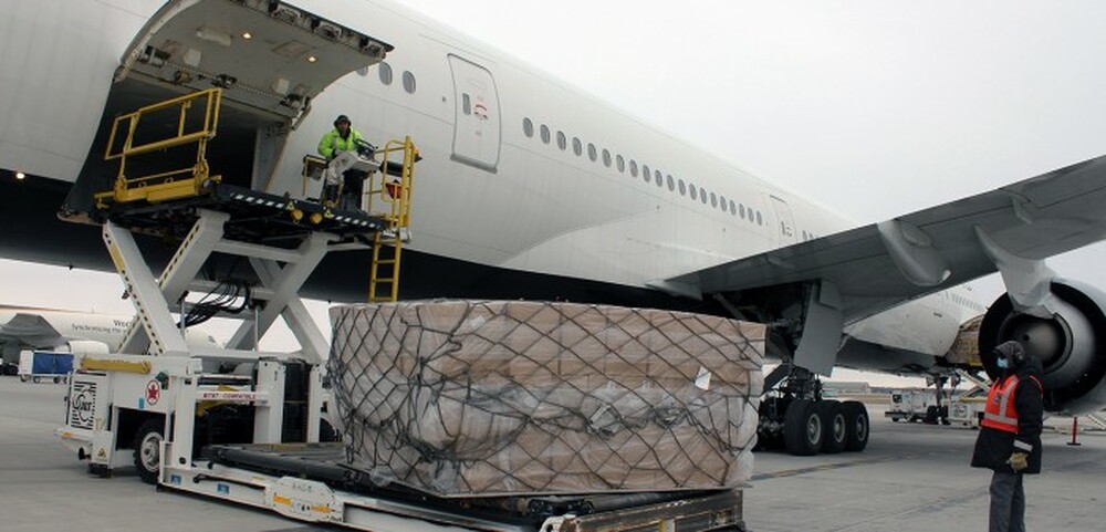 Cargo aircraft being unloaded on the airfield